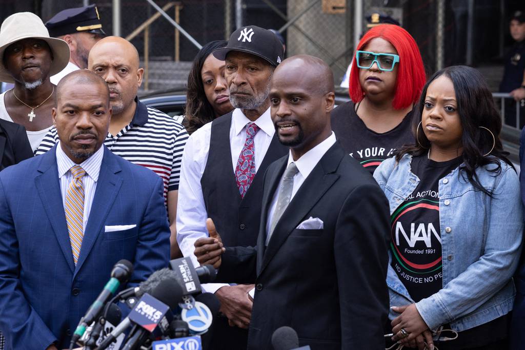 Donte Mills, a lawyer for the Neely family, with Andre Zachery (C L), father of Jordan Neely, speaks to the press outside Manhattan criminal court in New York, June 28, 2023. 