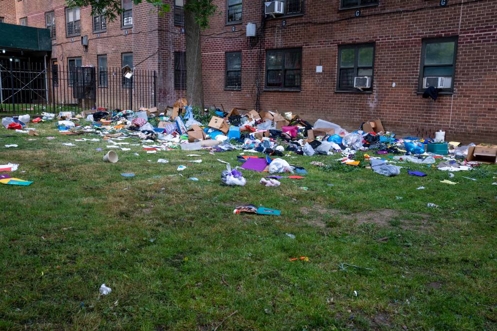 Debris is strewn outside the Butler Houses in the Bronx after firefighters extinguished a blaze that killed a 59-year-old resident.