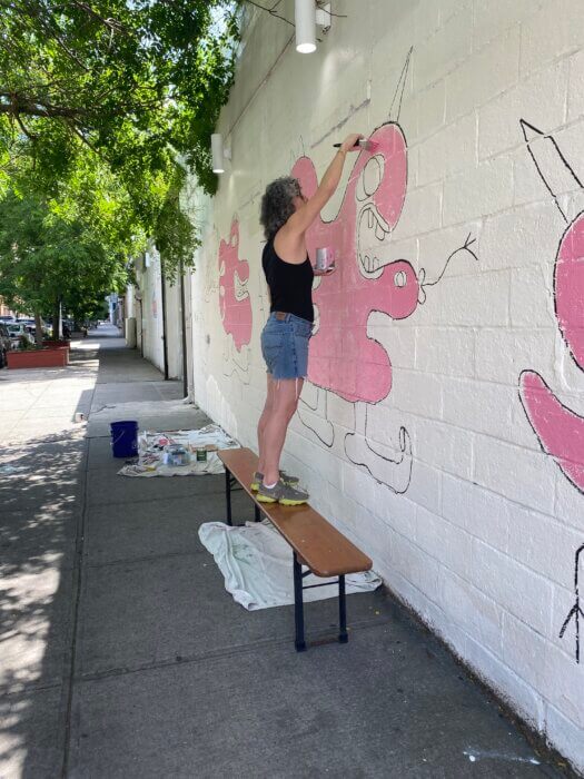 brooklyn buzzy working on mural 