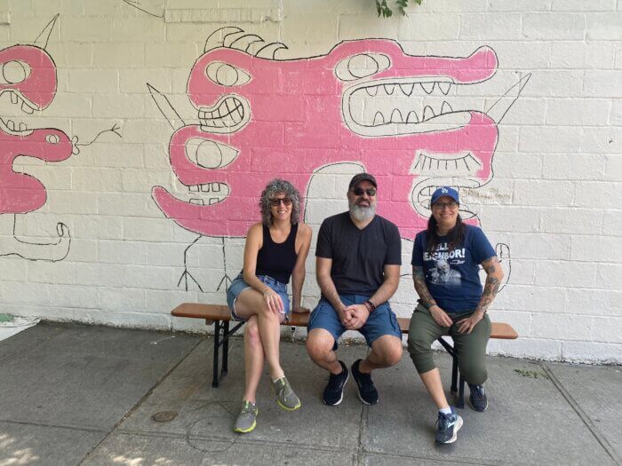 people outside the springs mural