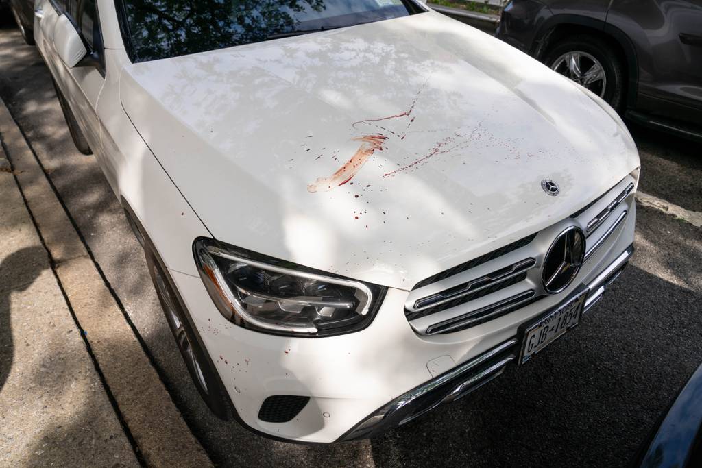 Blood is pictured on a parked Mercedes Benz SUV close to where the man was found Thursday morning. 