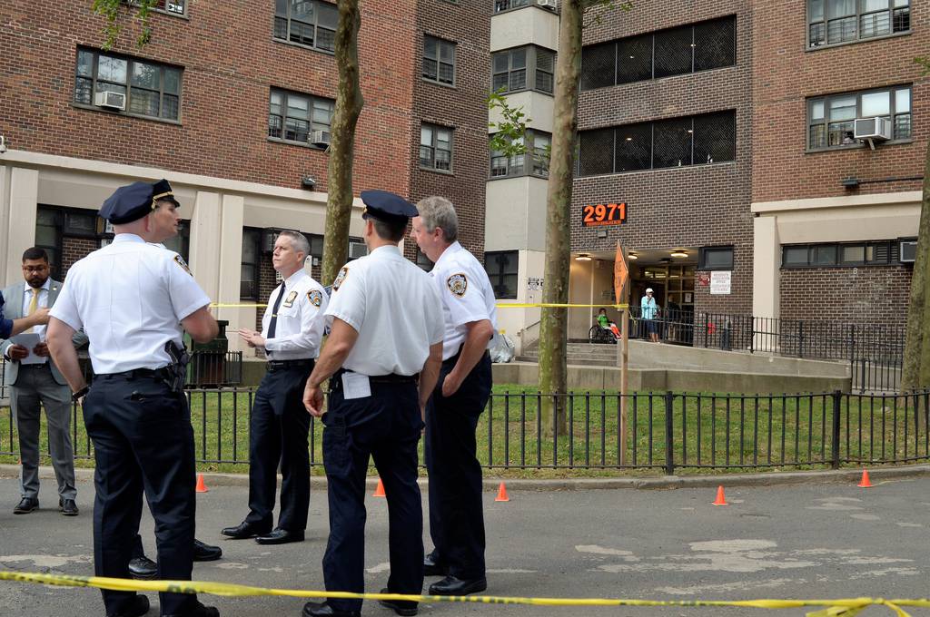 Police secure the walkway of NYCHA's Polo Ground Towers where a teen was fatally shot Wednesday.