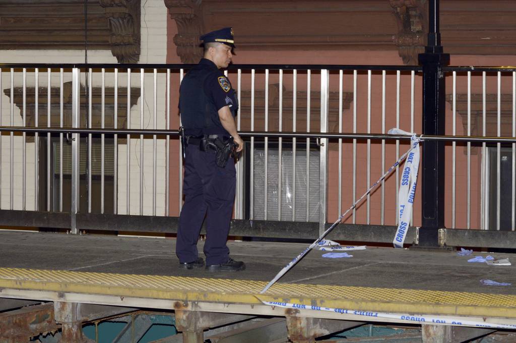 A Transit officer secures the platform of the Queens-bound Marcy Ave subway station on the J/Z/M line on Tuesday night.