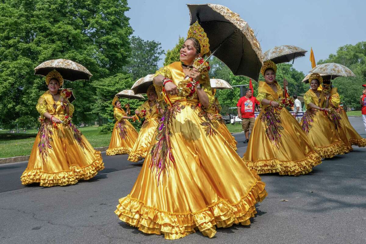 Carmela Dalisay and other dancers make their way through Washington Park during the Filipino Day parade on Saturday, July 1, 2023, in Albany, NY.