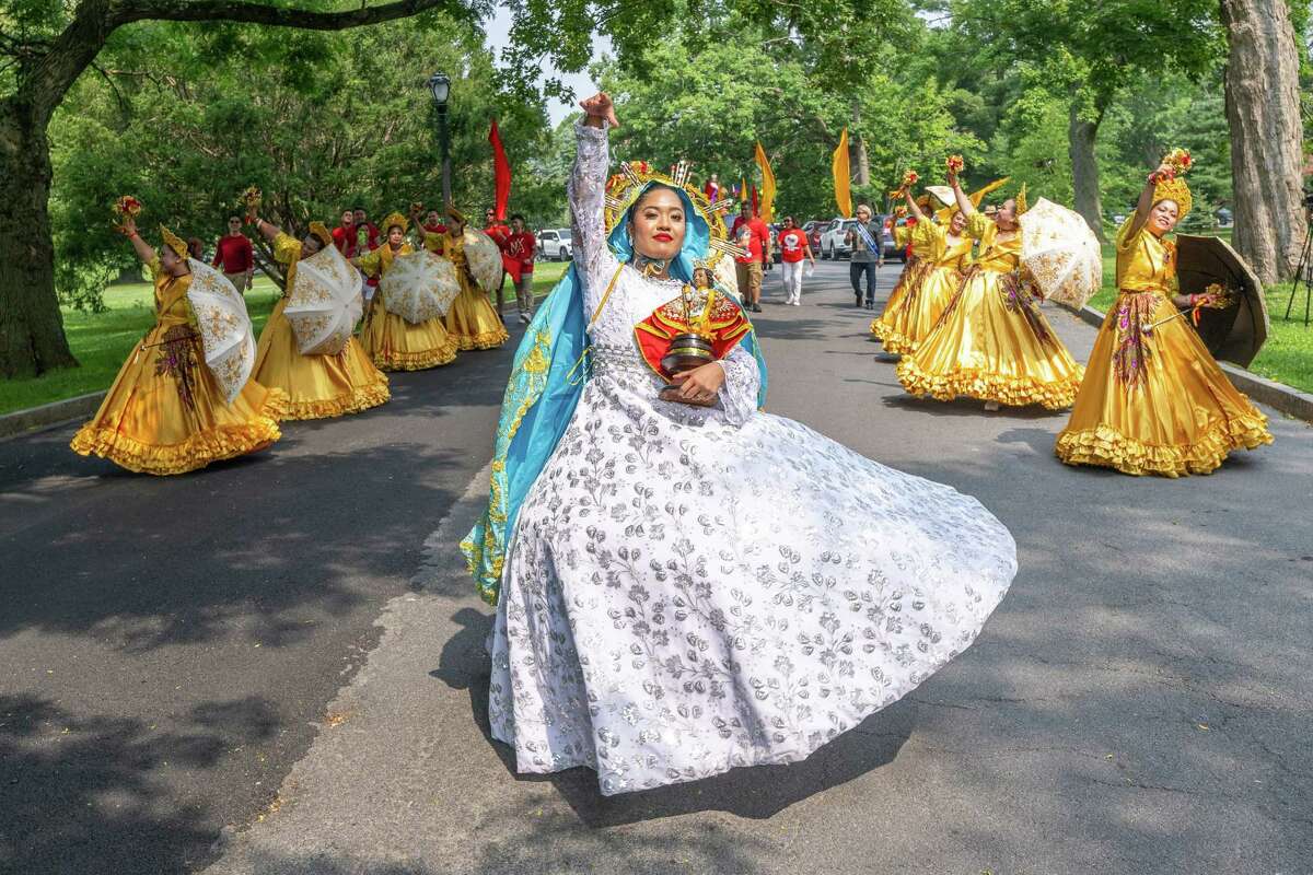 Thea Quilaton leads dancers through Washington Park during the Filipino Day parade on Saturday, July 1, 2023, in Albany, NY.