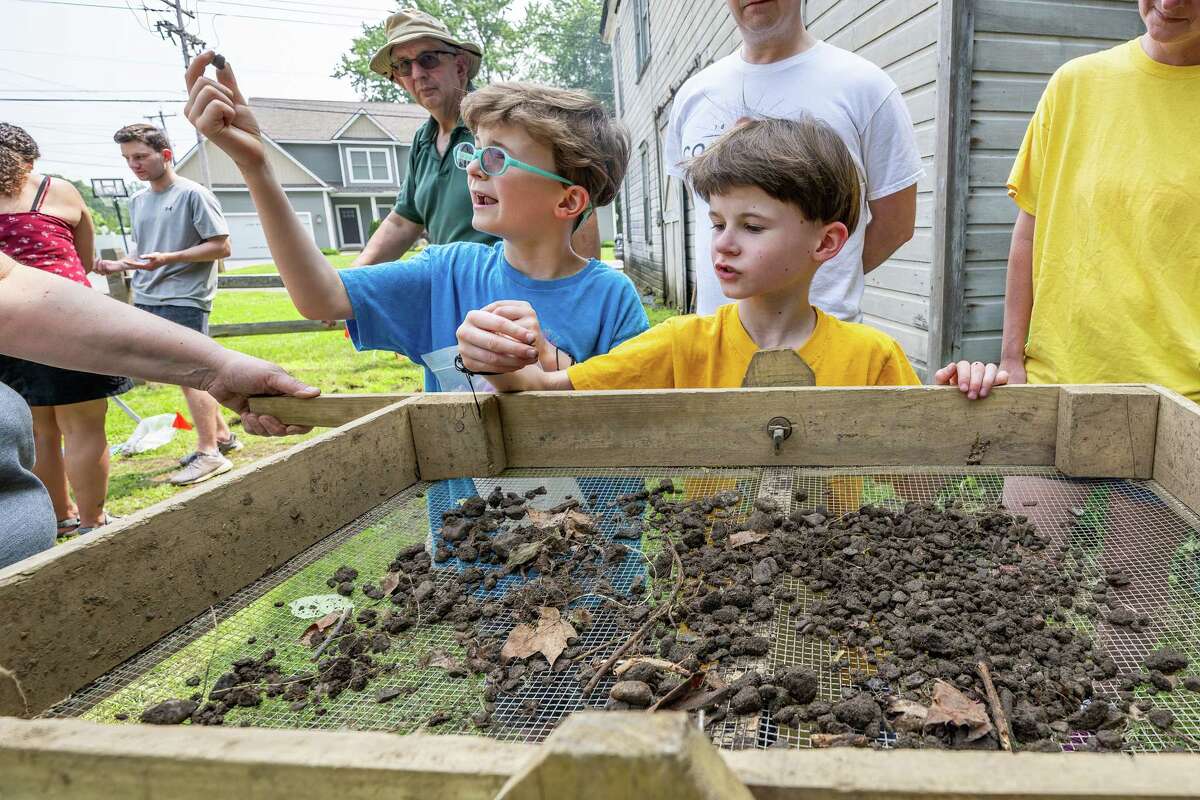 Jacob and James Molnar make a find while sifting through dirt during an archeological dig at the Historic Grooms Tavern and the adjacent former blacksmith shop on Saturday, July 1, 2023, in Rexford, NY. (Jim Franco/Times Union)