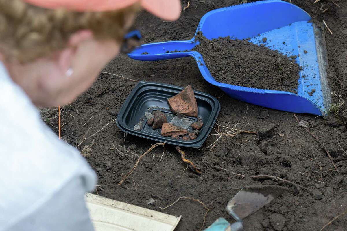 JoAnn Menzer uses a trowel to unearth pieces of pottery during an archeological dig at the Historic Grooms Tavern and the adjacent former blacksmith shop on Saturday, July 1, 2023, in Rexford, NY. (Jim Franco/Times Union)