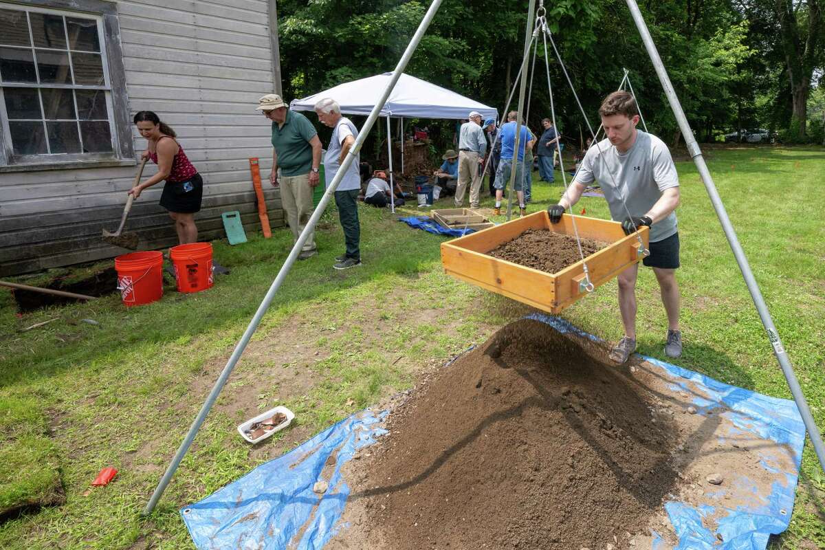 Jared Meisel sifts dirt during an archeological dig at the Historic Grooms Tavern and the adjacent former blacksmith shop on Saturday, July 1, 2023, in Rexford, NY. (Jim Franco/Times Union)