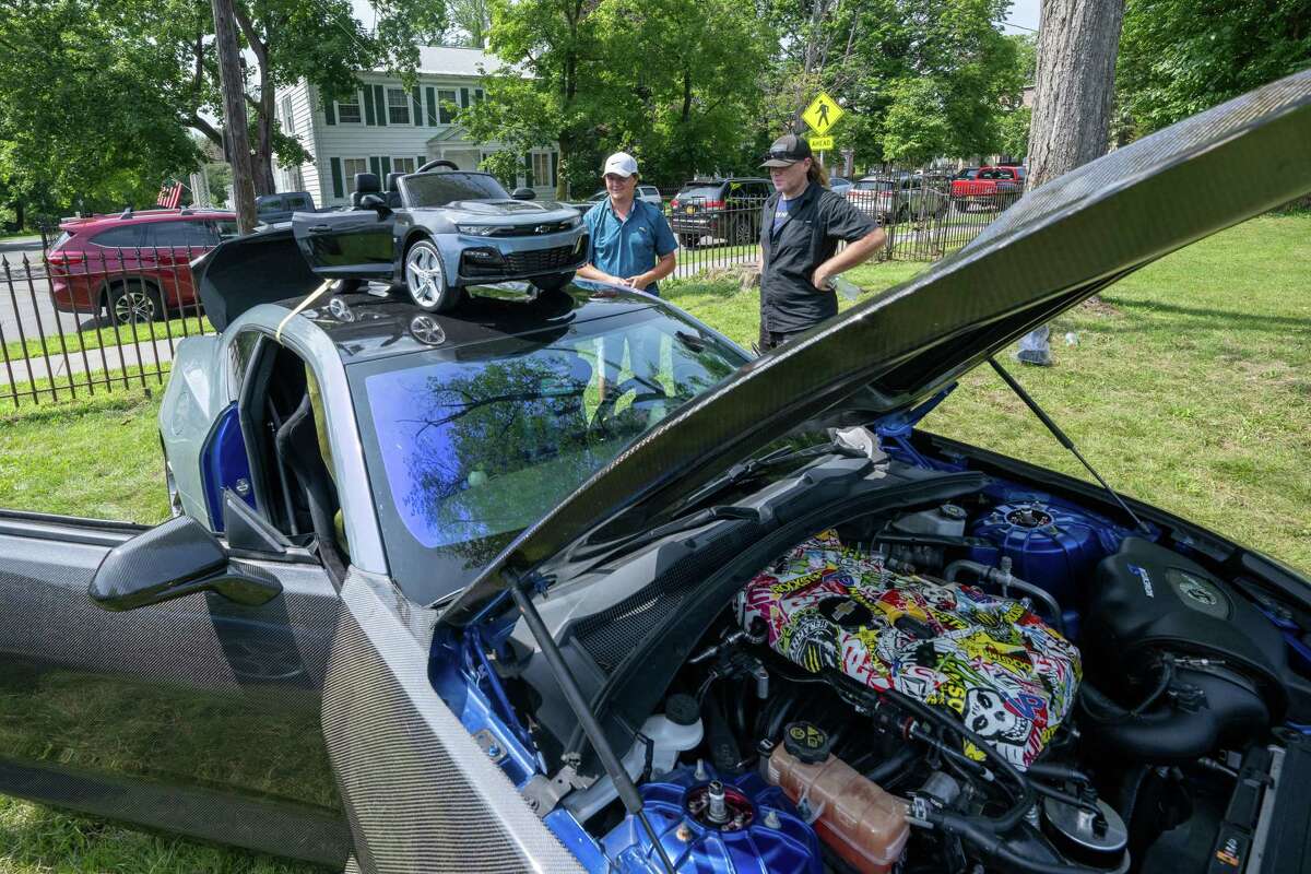 John Del Priore, left, and Craig Morehouse check out a 2018 Camaro during the Adirondack Muscle Car Show at the Powers Park Concert Series, which kicked off its 20th season on Saturday in Troy.