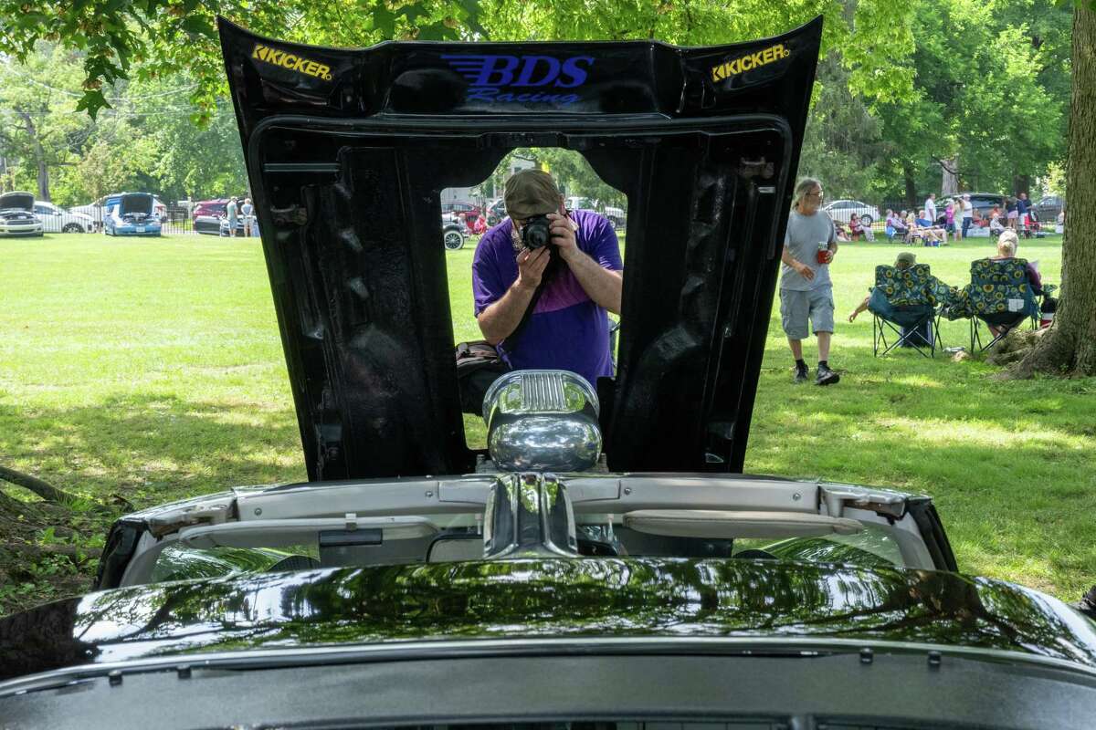 Martin Vuillemot photographs a 1978 Corvette during the Adirondack Muscle Car Show at the Powers Park Concert Series, which kicked off its 20th season on Saturday in Troy.