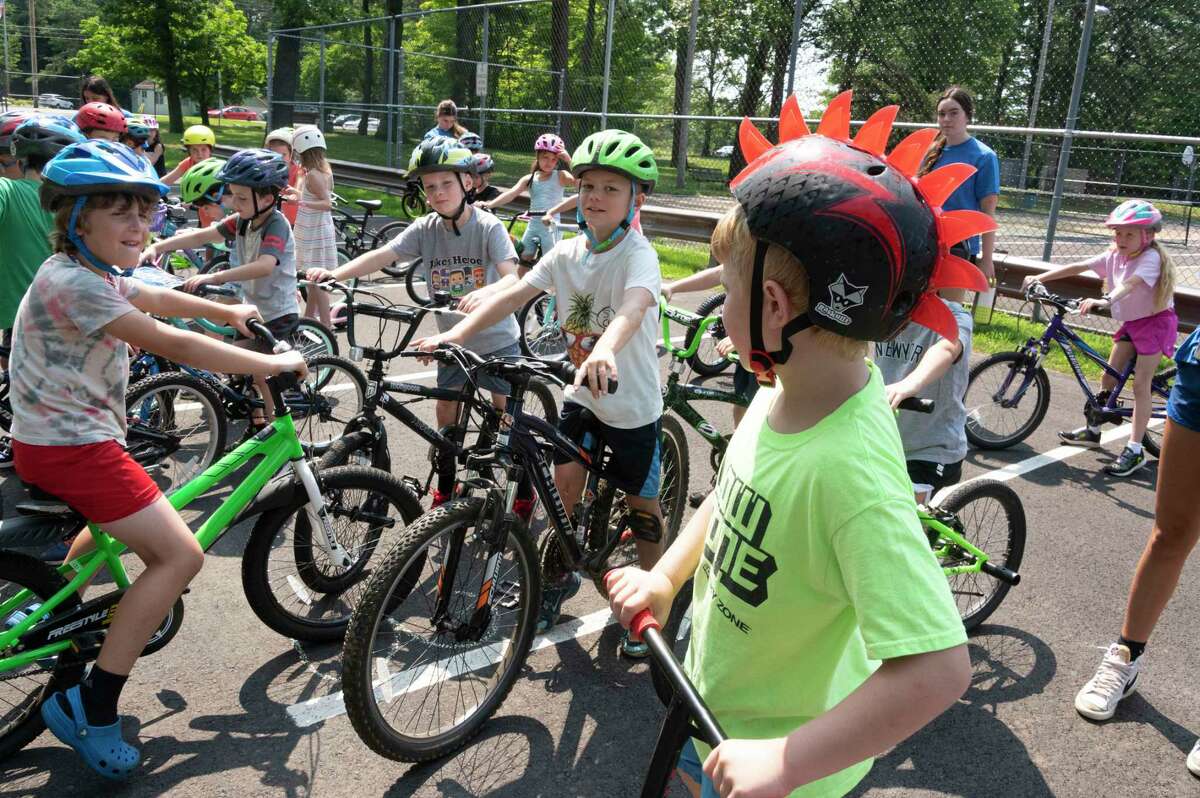 Children get ready to ride their bikes and scooters during the 25th annual Safe Summer Bike Helmet Program on Tuesday at Burgess Kimball Memorial Park in Ballston Spa.