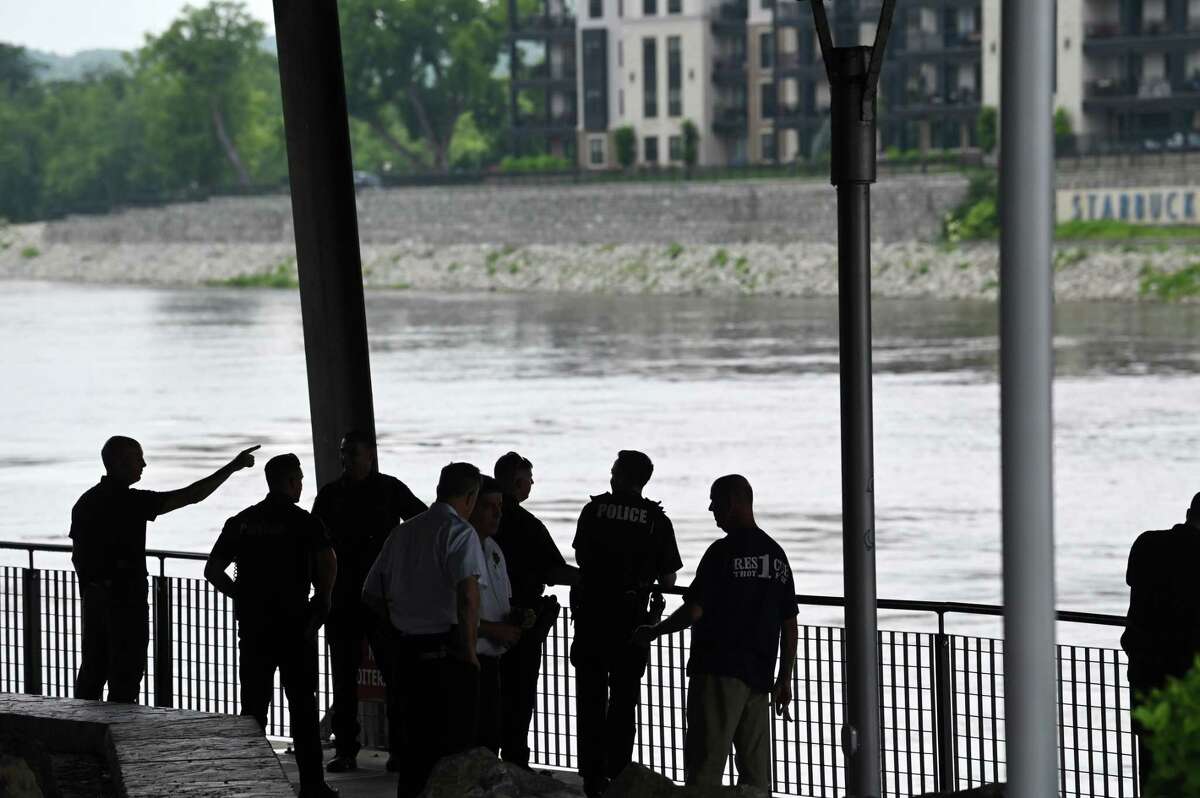 Emergency personnel gather under Green Island Bridge at Troy Downtown Marina after a dead body was seen floating down the Hudson River on Wednesday, July 12, 2023, in Troy, N.Y. A body was recovered from the river.