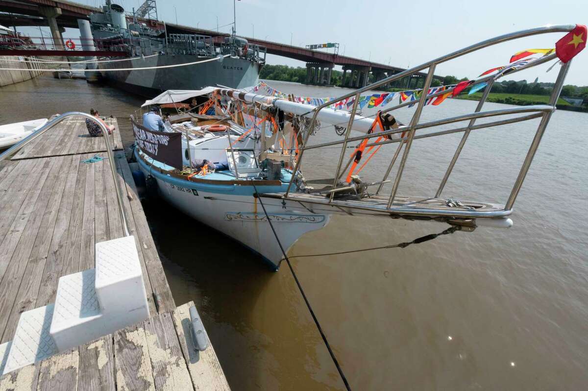 Flags from different countries fly on the lowered mast of the Golden Rule Peace Boat on Wednesday in Albany.