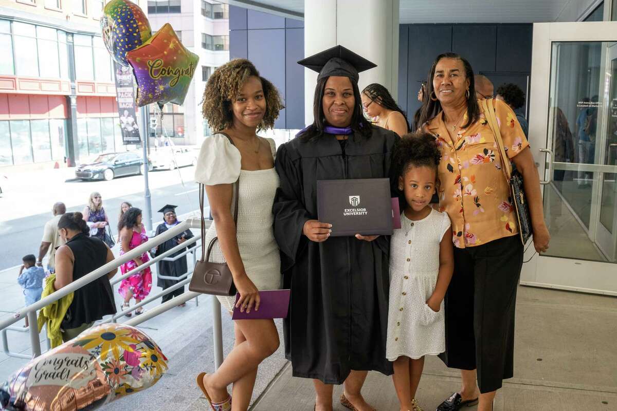 From left: Nyla Crudup, Excelsior University graduate Pamela Hargrove, London Hargrove and Pat Perry following the Excelsior University commencement exercise on Friday at the MVP Arena in Albany.