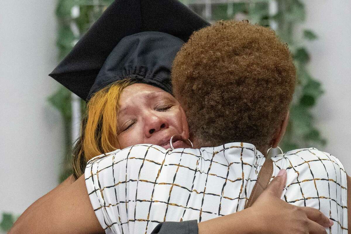 Taheesha Robinson-Hines tears up as she hugs her mother, Brenda Robinson, after getting her diploma from Excelsior University on Friday at the MVP Arena in Albany.