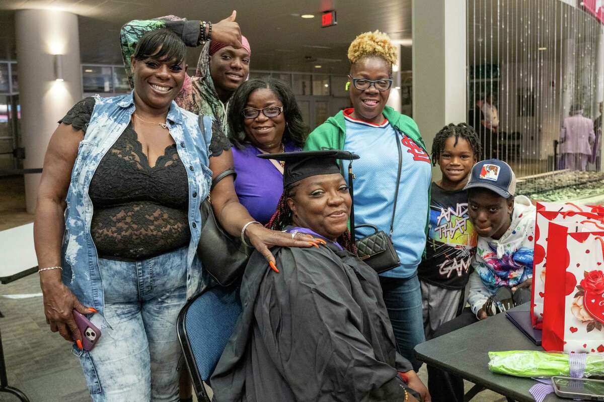 Excelsior University graduate Carrie Hightower, center, poses for a photo with family and friends on Friday at the MVP Arena in Albany.