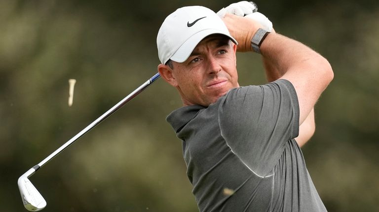 Rory McIlroy watches his tee shot on the 12th hole...