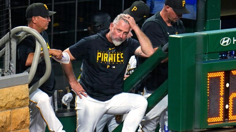 Pittsburgh Pirates manager Derek Shelton stands on the dugout steps...