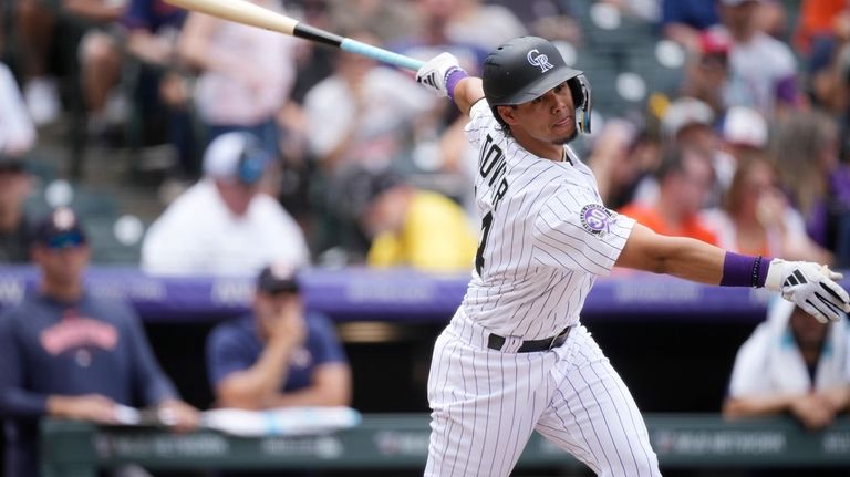 Colorado Rockies' Ezequiel Tovar strikes out against Houston Astros starting...