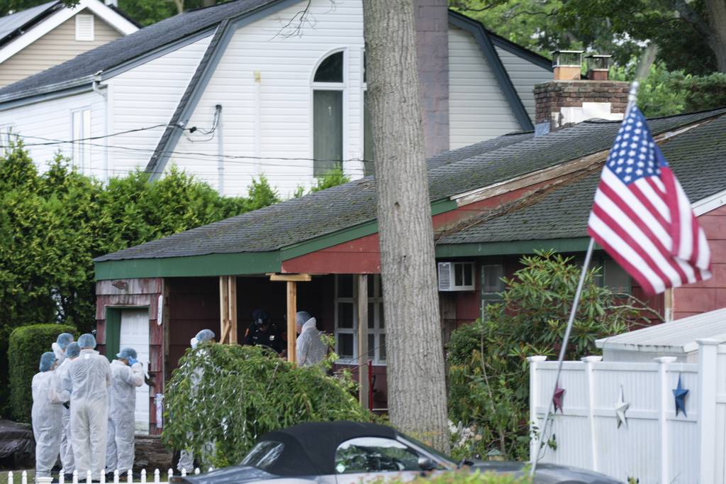 Crime laboratory officers arrive to the house where a suspect has been taken into custody on New York's Long Island in connection with a long-unsolved string of killings, known as the Gilgo Beach murders, Friday, July 14, 2023, in Massapequa Park, N.Y. 