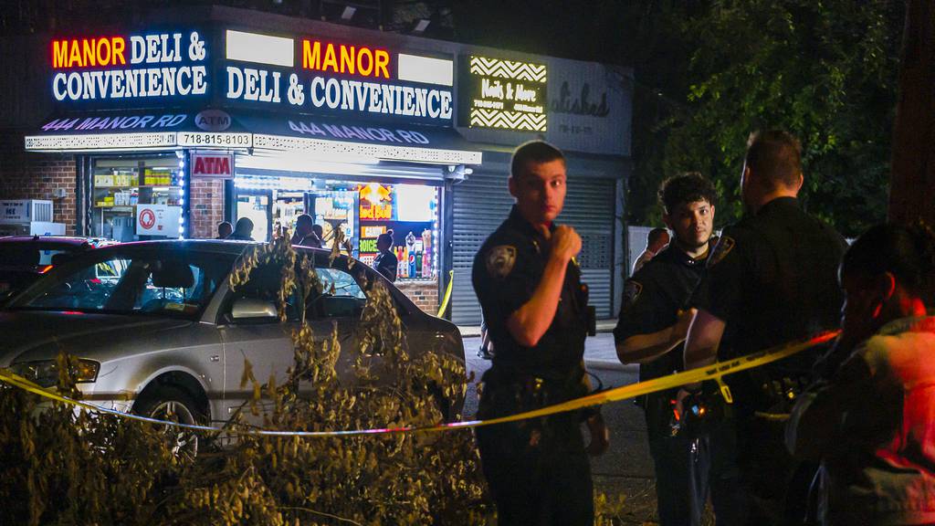 NYPD officers and detectives gather evidence at the deli on Manor Road in Castleton Corners after the owner was fatally shot during a botched robbery Saturday.