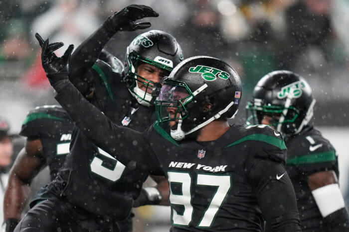 Jets linebacker Kwon Alexander (9) celebrates with defensive tackle Nathan Shepherd (97) after a defensive play against the Jacksonville Jaguars.