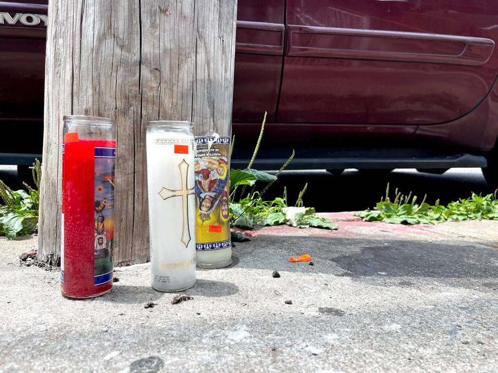 Prayer candles at the scene where Kyle Danielson's body was found in a garbage bag on 104th St. in East Elmhurst, Queens.