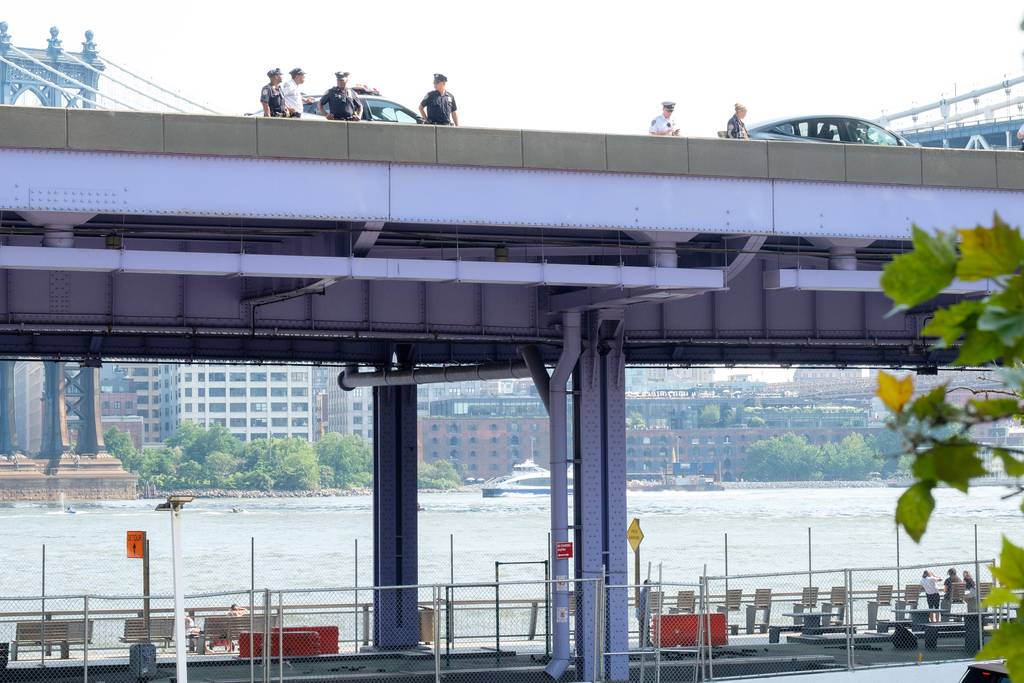 Cops investigate after a Lyft driver was stabbed during an attempted carjacking on an elevated portion of the FDR Drive in Manhattan Tuesday.