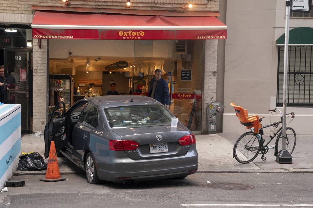 Road rage crash suspect Andrew Mosby's Volkswagen after it fatally struck a 54-year-old man is pictured on E. 60th St. on Wednesday. Mosby's wife and children were with him in the car.