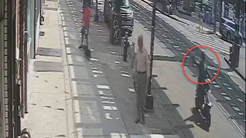 The gunman on a moped is pictured shooting Hamoud Saeidi in a random attack on Sunday. 