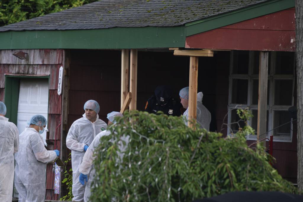 Crime laboratory officers arrive to the house where a suspect has been taken into custody on New York's Long Island in connection with a long-unsolved string of killings, on Friday, July 14, 2023, in New York. 