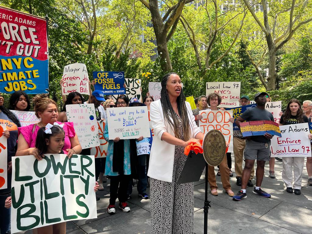 Dozens gathered in the scorching July heat on Thursday outside City Hall in support of Local Law 97, which sets carbon emission limits for tens of thousands of New York’s largest buildings beginning next year. Those out of compliance will face hefty fines.