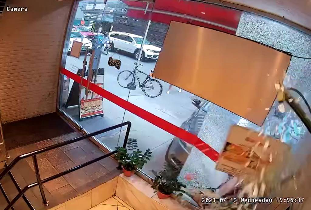 A screengrab from surveillance video shows Andrew Mosby's car smashing through the glass of a cafe.