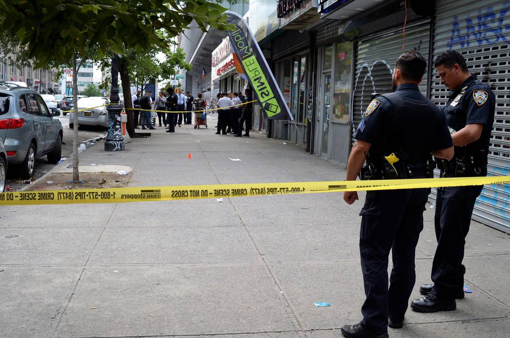 Police secure the scene in front of 281 E. 161 St. in the Bronx where a Denzel Plummer was shot on Friday.