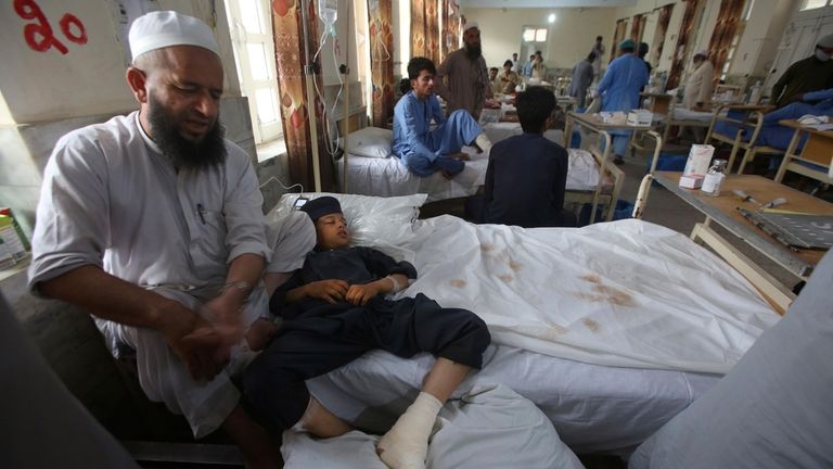 Injured people lie on the bed at a hospital after...