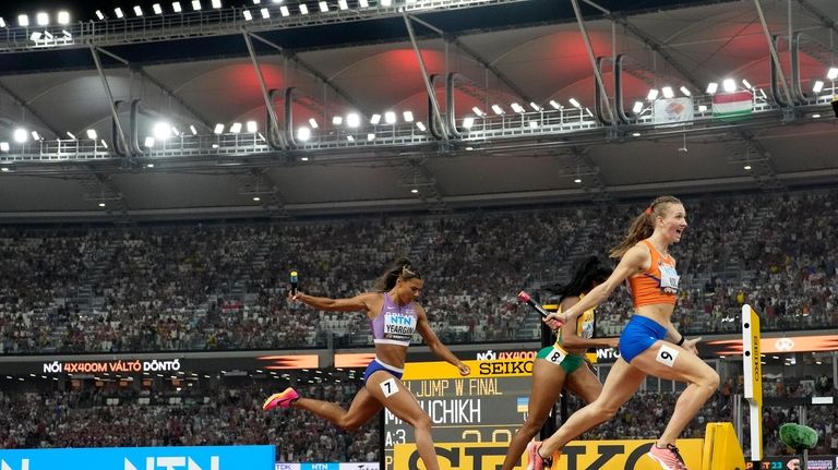 Femke Bol, of the Netherlands crosses the line to win...