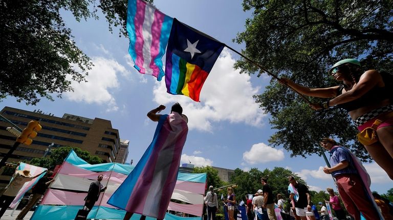 Demonstrators gather on the steps to the Texas Capitol to...