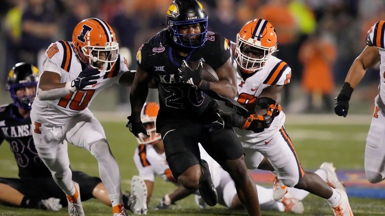 Kansas running back Daniel Hishaw Jr. (20) is chased by...