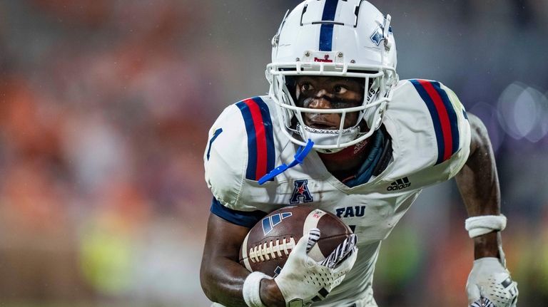 Florida Atlantic wide receiver LaJohntay Wester runs with the ball...