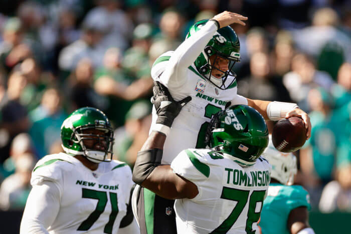 Jets quarterback Zach Wilson (2) celebrates with guard Laken Tomlinson (78) after scoring a touchdown.