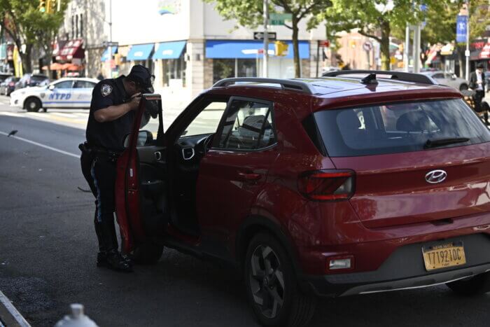 Brooklyn police photograph vehicle after SUV driver strikes man