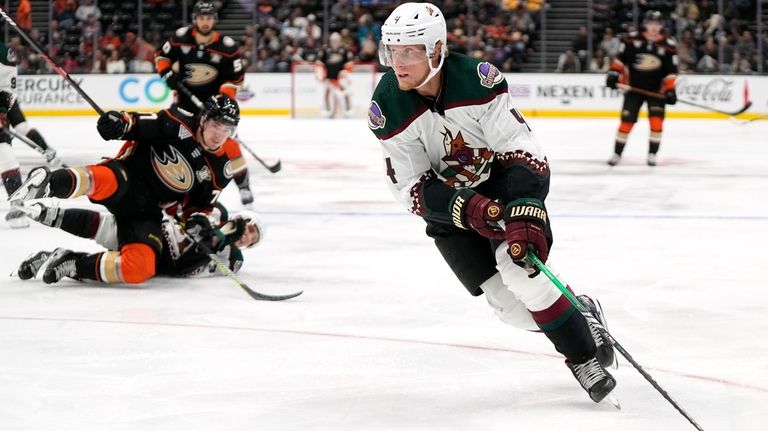 Arizona Coyotes defenseman Juuso Valimaki moves the puck during the...