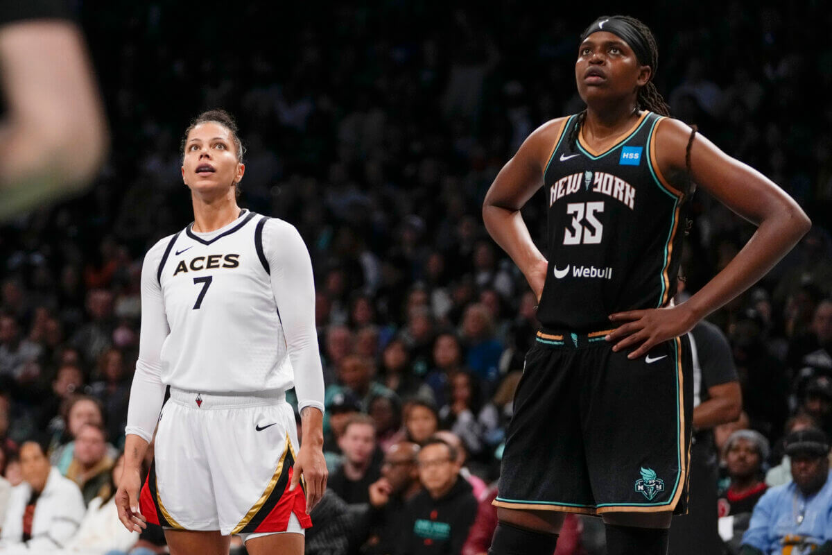 Las Vegas Aces' Alysha Clark (7) and New York Liberty's Jonquel Jones (35) watch a free throw attempt