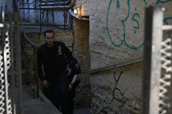 Cops leave the apartment where the shooting took place.