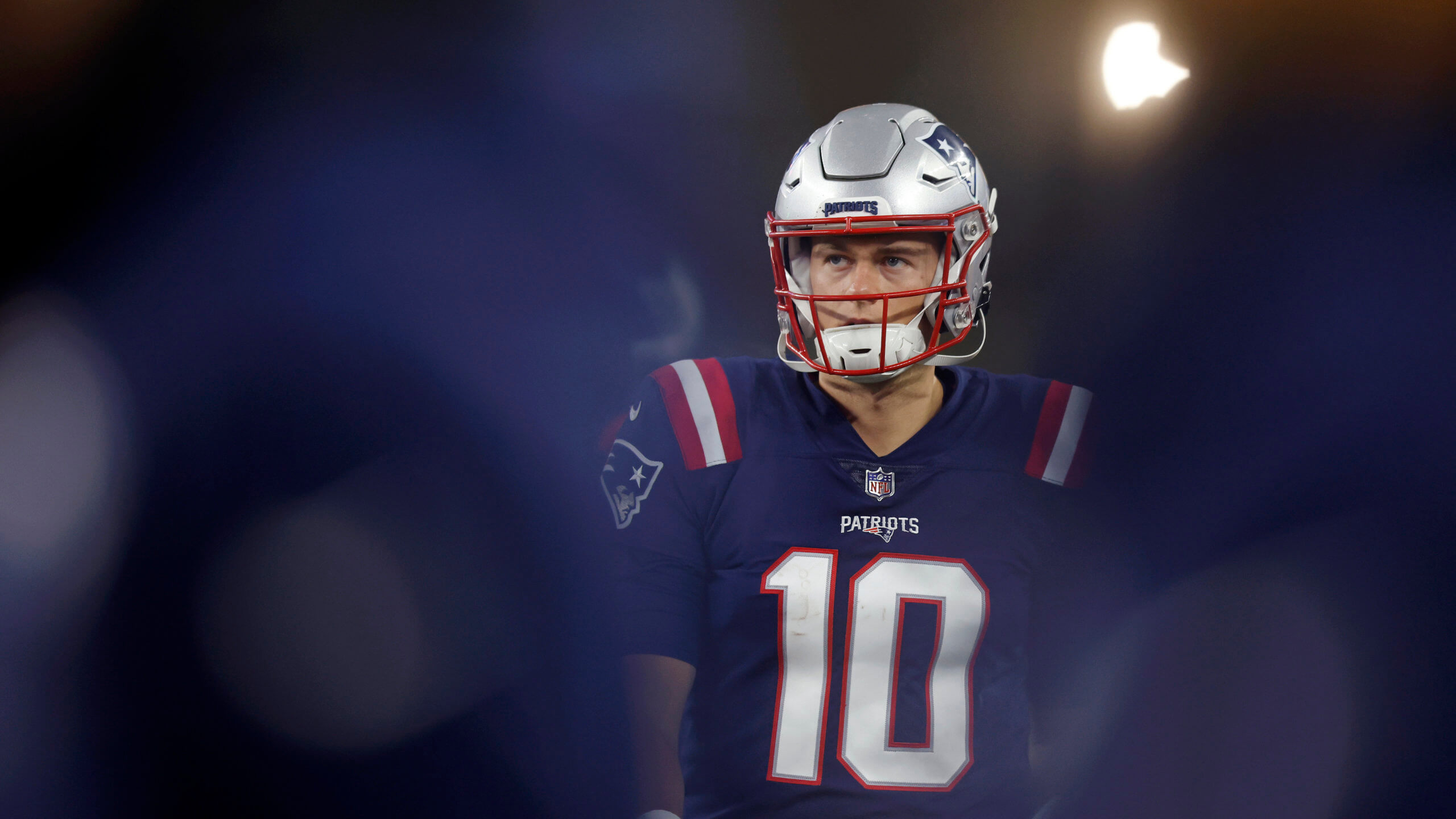 New England Patriots quarterback Mac Jones, who will start against the Jets, stands on the sidelines.