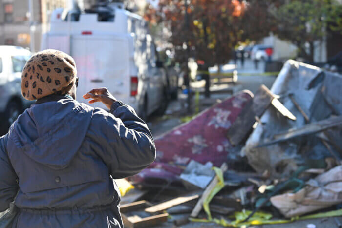 woman looking at fire debris