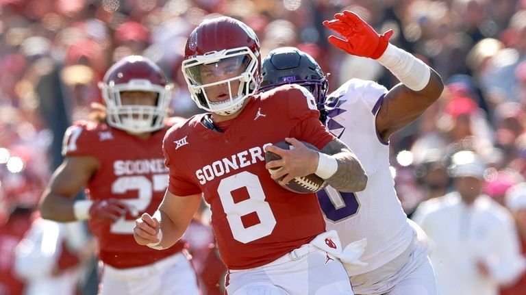 Oklahoma quarterback Dillon Gabriel (8) runs ahead of TCU linebacker...