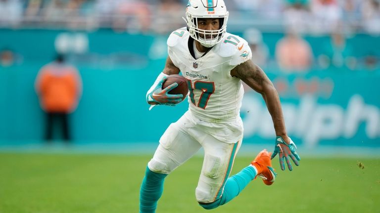 Miami Dolphins wide receiver Jaylen Waddle (17) runs with the...