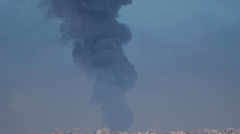 Smoke rises following an Israeli airstrike in the Gaza Strip,...