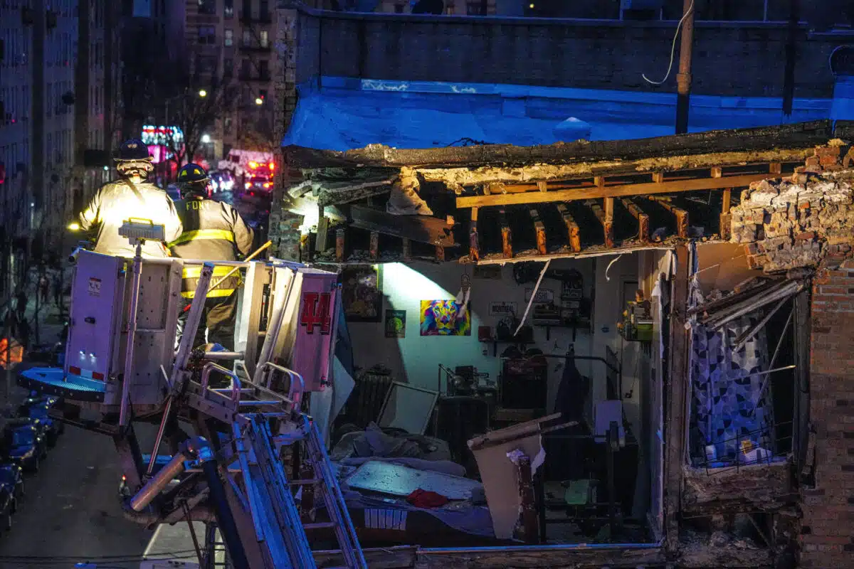 Firefighters on ladder searching Bronx collapse site